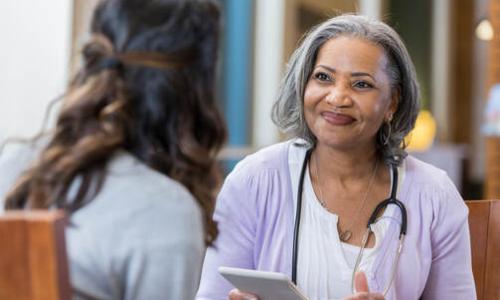 Senior female counselor meets with female resident