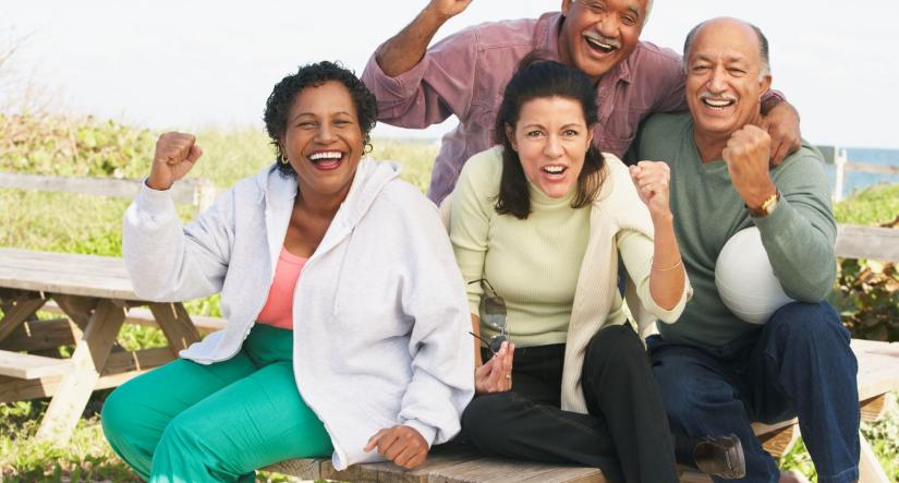 Group of middle aged men and women cheering